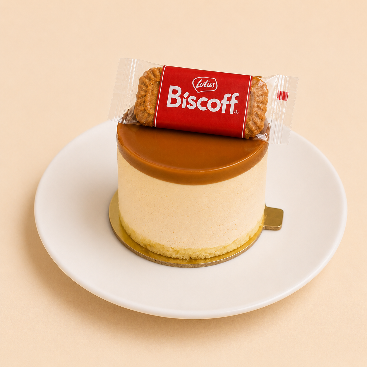Individual Biscoff cheesecake with spread glaze and a wrapped Lotus biscuit